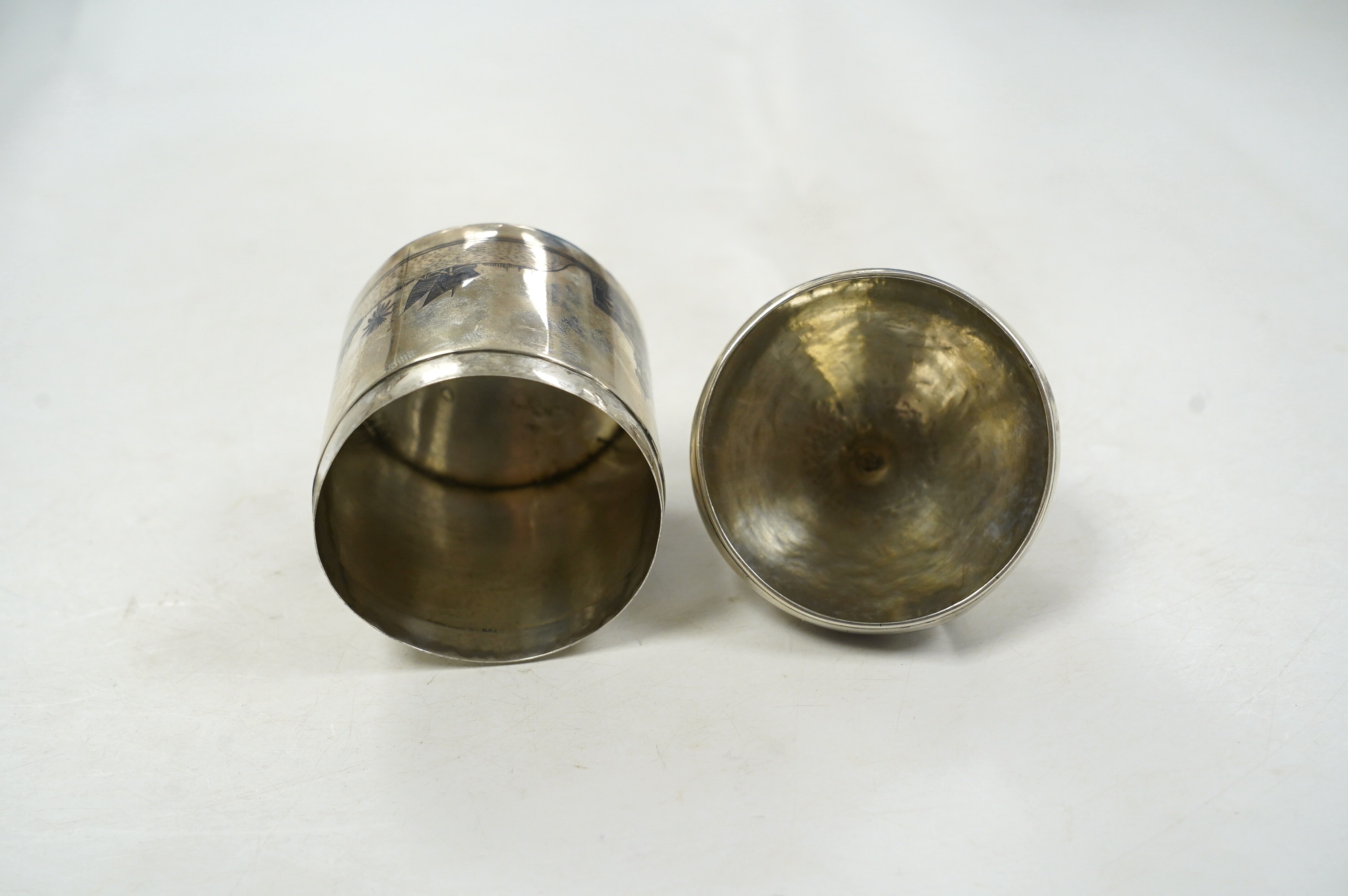 A Middle Eastern white metal and niello box and cover, with cross finial, 11.8cm, gross weight 4.4oz. Condition - poor to fair